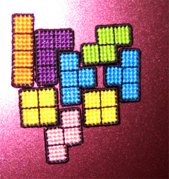 Cross Stitched Tetris Magnets on Pink Whiteboard