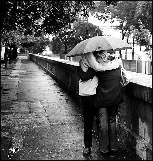 romantic couple kissing in rain. romantic couple kissing in