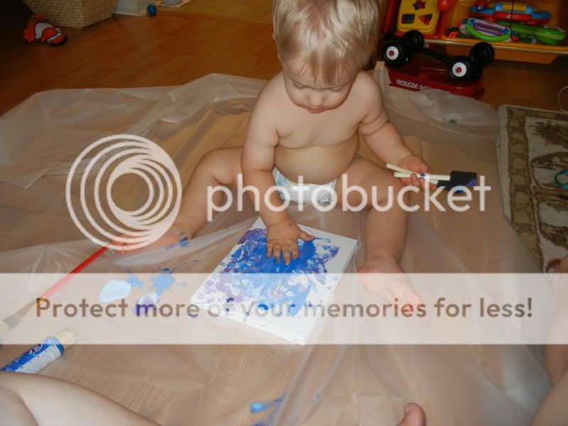 baby painting a canvas 