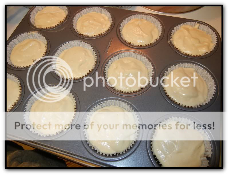 cupcake batter in a paper cups in a cupcake pan 