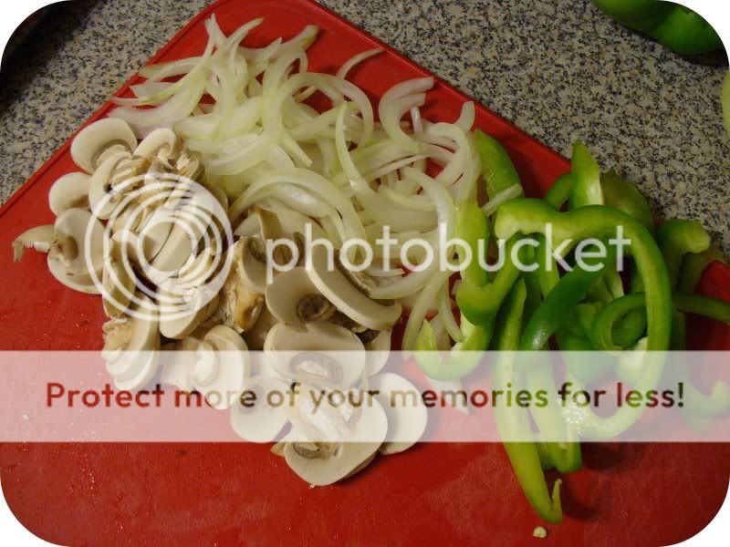 sliced mushrooms, onions, and green peppers on a red cutting board 