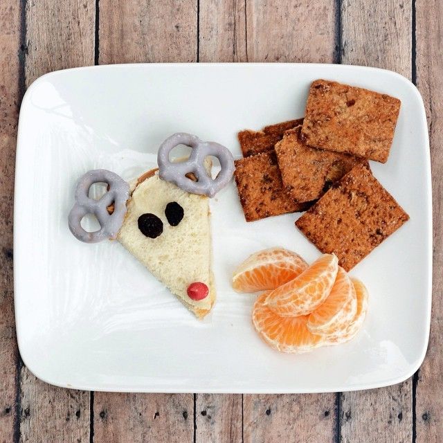 Cute, healthy snack for kids made from Naturebox CCranberry Pepita Crisps, Blueberry Greek Yogurt Covered Pretzels for reindeer antlers, and a few orange slices