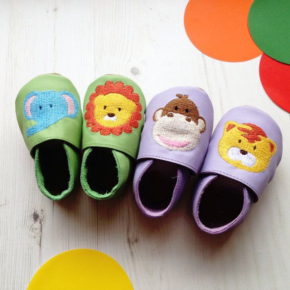 Personalized handmade baby shoes with animals on the top, a name or birth date on the bottom