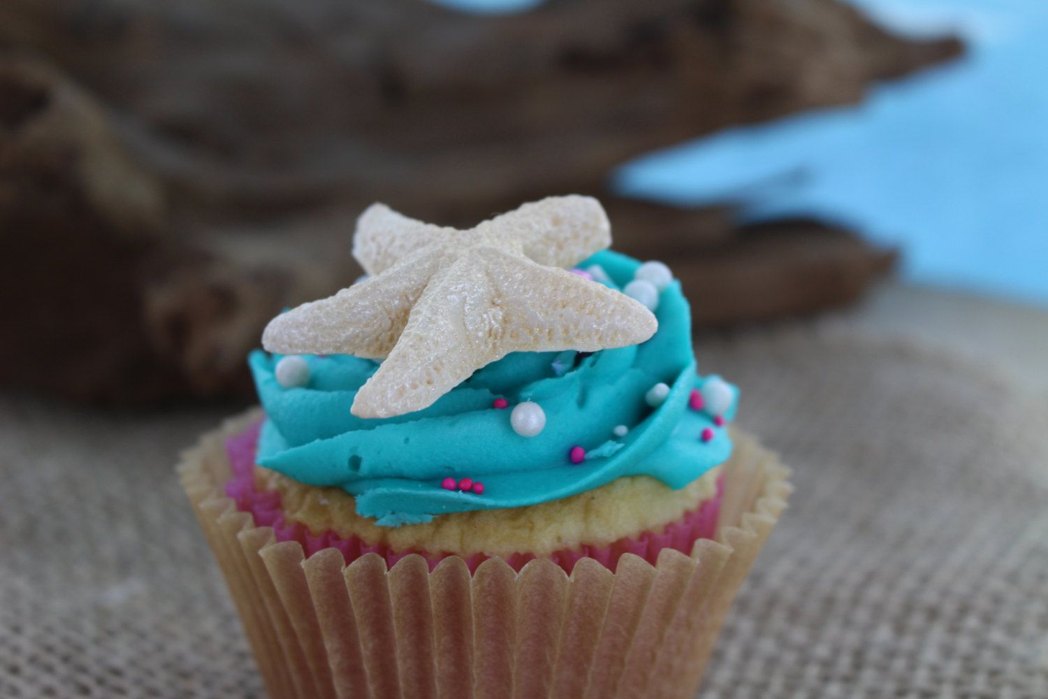 Top cupcakes or a store-bought cake with edible seashell candies for a creative pirate party treat idea