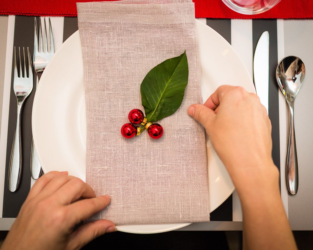 Easy holiday table setting idea: DIY holly using a fresh leaf and 3 tiny Christmas balls