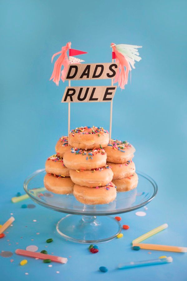 Make a DIY donut "cake" and top with your own handmade cake topper | via Oh Happy Day