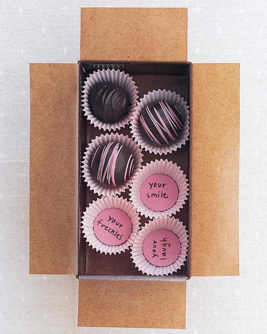 Love this! Place sweet sayings on little discs in a candy wrapper, then replace the truffles...or add your own or even chocolate kisses. Via Martha Stewart